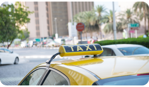 Photo of the top of a yellow Taxi in Dubai.